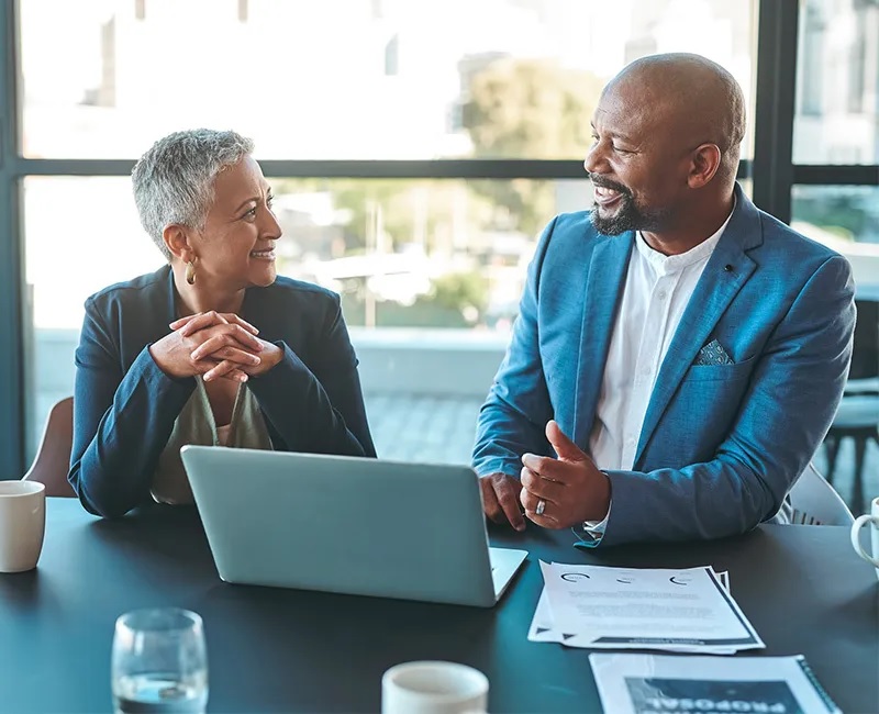 Business owner reviewing financing options with a High Rage Trust banker