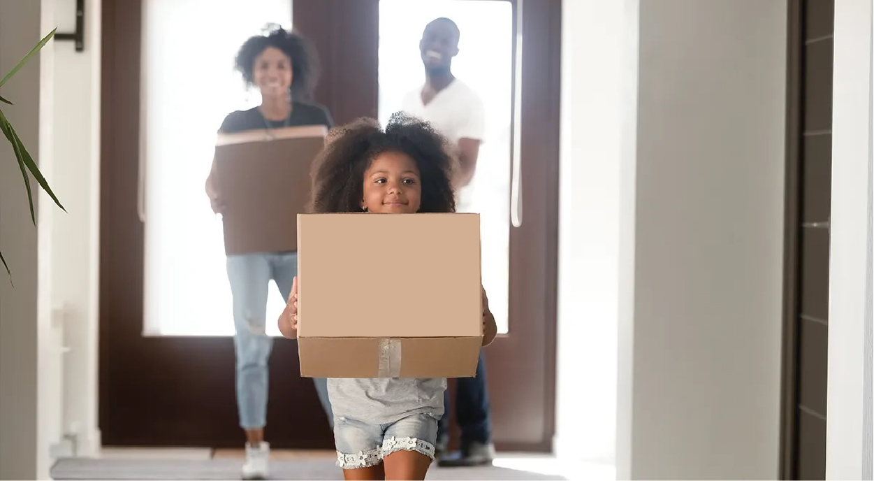 Family standing in front of their new home